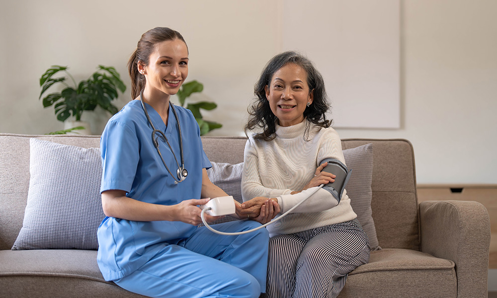 happy-senior-woman-having-her-blood-pressure-measu-DUDY2M8